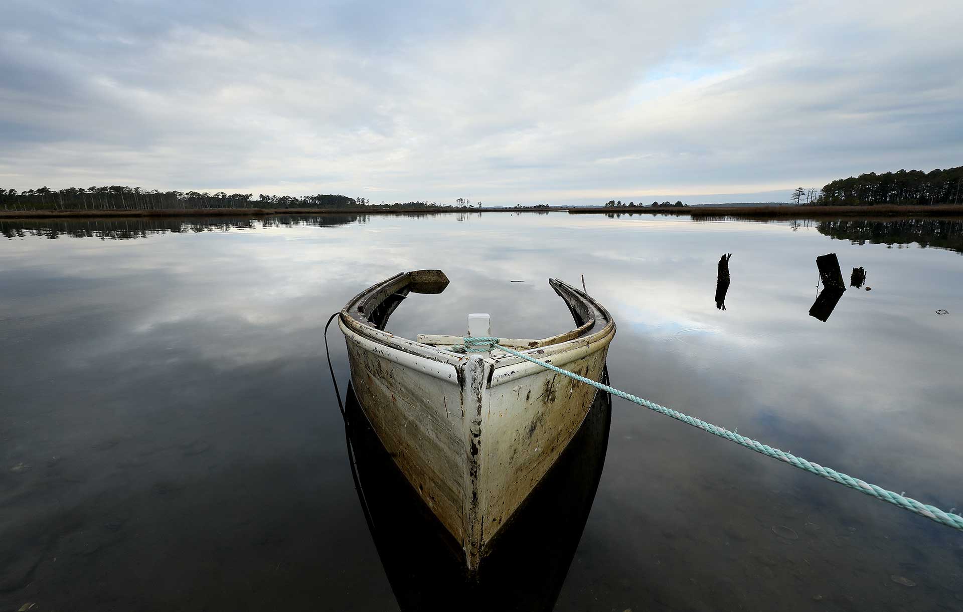 Flooded boat tied to a pier in the Virginia Middle Peninsula