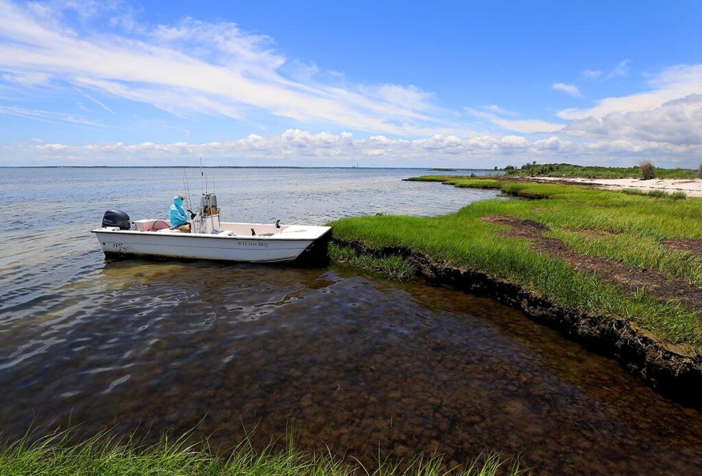 Boat pulling up to the Guinea marsh islands
